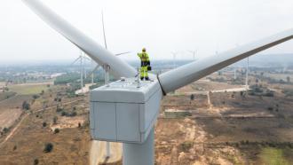 wind turbine tech on turbine with full safety gear