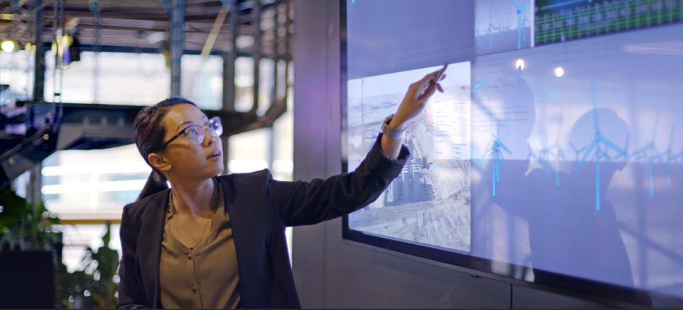 woman in meeting in front of large screen